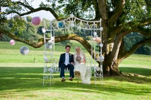 bride and groom on a vintage swing at boconnoc wedding venue in cornwall